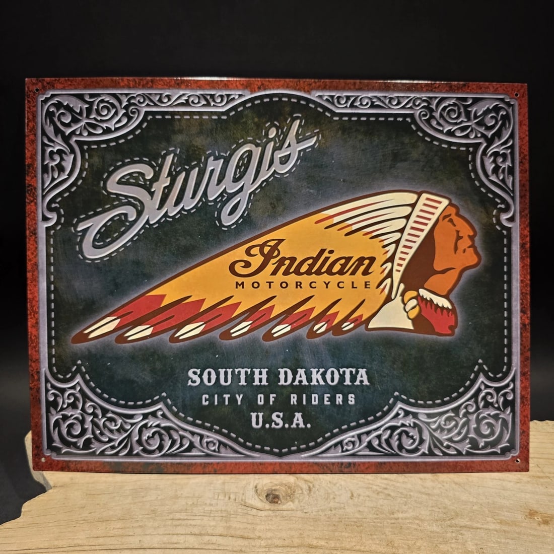 Vintage Style Sturgis Indian Motorcycle Tin Sign: 16" x 12 1/2" Such a neat reproduction metal Vintage Style Indian motorcycle sign featuring Sturgis Indian Motorcycle graphics with a Native American head logo and "South Dakota City of Riders" wordin