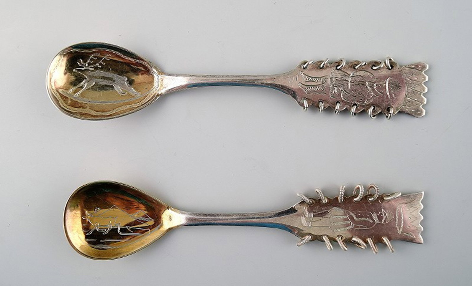 Sami/Lapps spoons in silver. Motif of moose and man in national costume. 2 pcs. in stock.: Title:Sami/Lapps spoons in silver. Motif of moose and man in national costume. 2 pcs. in stock. Description:2 Sami/Lapps spoons in silver. Motif of moose and man in national costume. Marked. In near