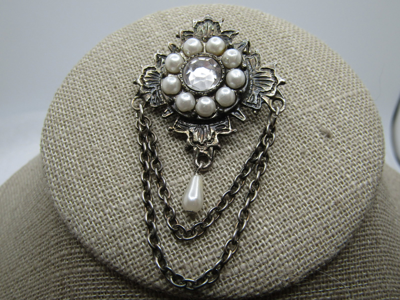 Vintage Faux Pearl Rhinestone Swag Brooch, 1960's-1970's, signed: Title: Vintage Faux Pearl Rhinestone Swag Brooch, 1960's-1970's, signed Description: Vintage Faux Pearl Rhinestone Swag Brooch, 1960's-1970's. It is appx. 2.25" long and 1.25" wide. Silver tone. It