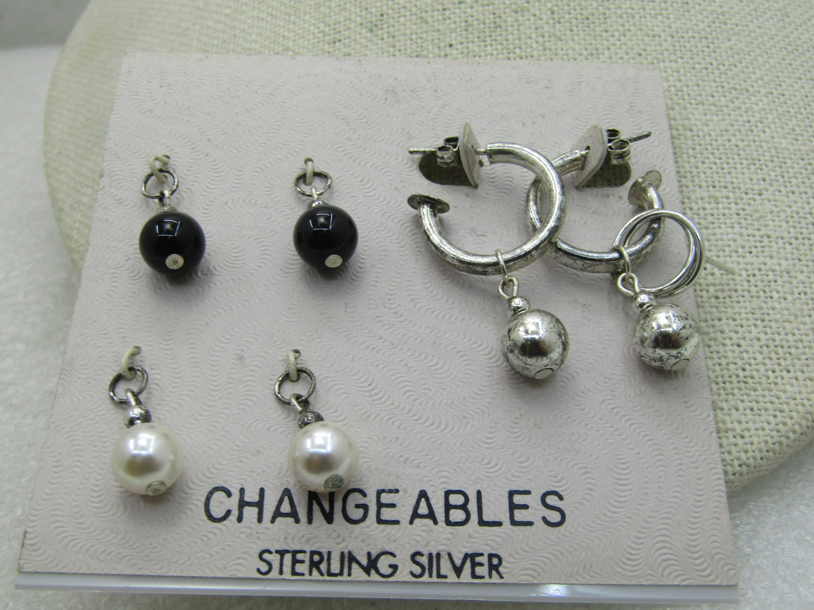 Changeable Sterling Silver Hoop Pierced Earrings, with Beaded Slides, Vintage new on card: Title: Changeable Sterling Silver Hoop Pierced Earrings, with Beaded Slides, Vintage new on card Description: . 3/4 round tubular hoop pierced earrings with appx. 8mm black, faux pearl, and silver ton
