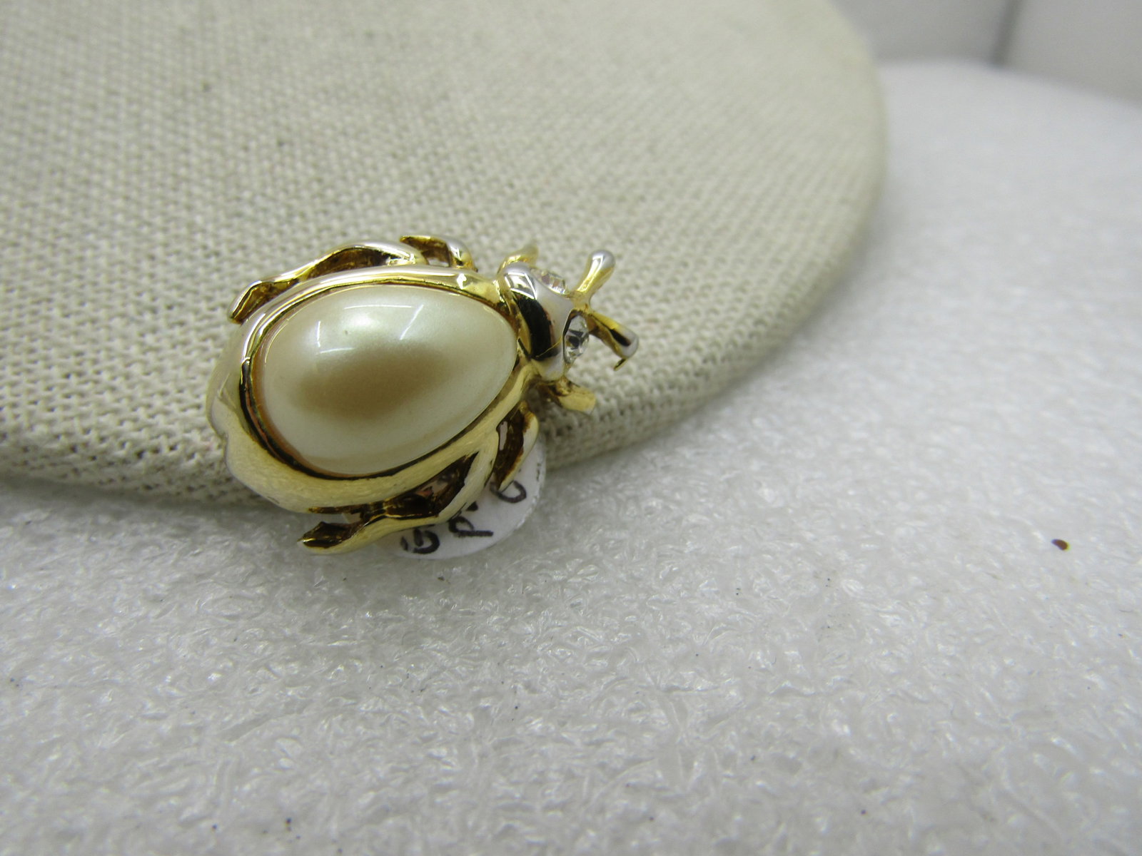 Vintage Faux Pearl Rhinestone Fly/Bug Brooch: Title: Vintage Faux Pearl Rhinestone Fly/Bug Brooch Description: Vintage Faux Pearl Rhinestone Fly/Bug Brooch, 1980's-1990's. Tear-drop faux pearl cabochon as the back and rhinestone eyes. Gold Tone,