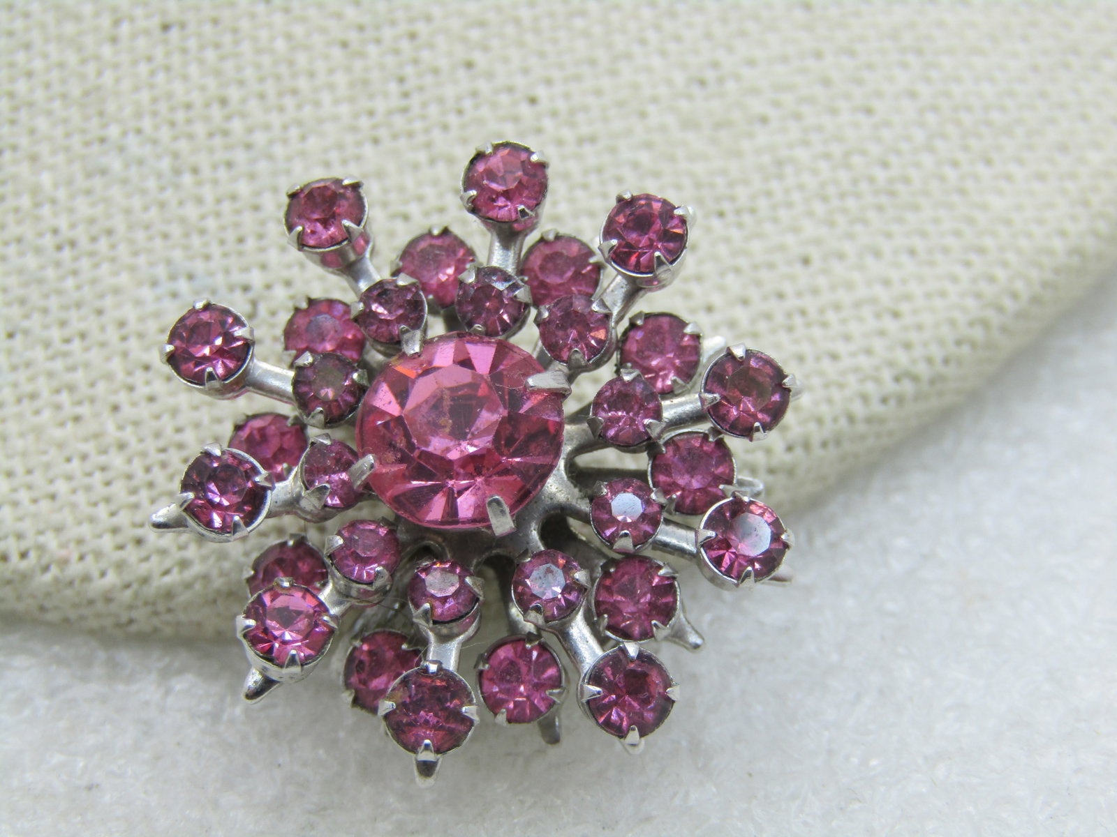 Vintage Pink Rhinestone Brooch Pendant, Starburst/Blossom: Title: Vintage Pink Rhinestone Brooch Pendant, Starburst/Blossom Description: Vintage Pink Rhinestone Brooch Pendant, Starburst/Blossom1-1/8" across, tiered with shorter and longer rays, each with a r