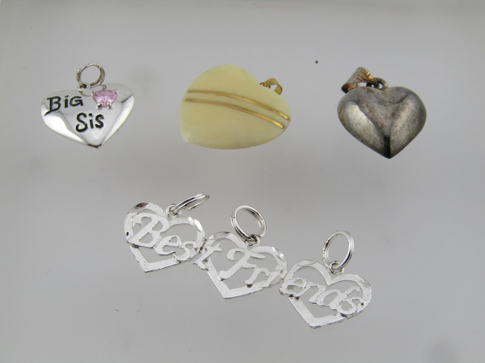 Three Silver Tone Pendants, Best Friends, Heart, Big Sis: Title: Three Silver Tone Pendants, Best Friends, Heart, Big Sis Description: Three Silver Tone Pendants, All heart themed and age is estimated at 1980's-1990's or slightly after. Best Friends, Heart, 
