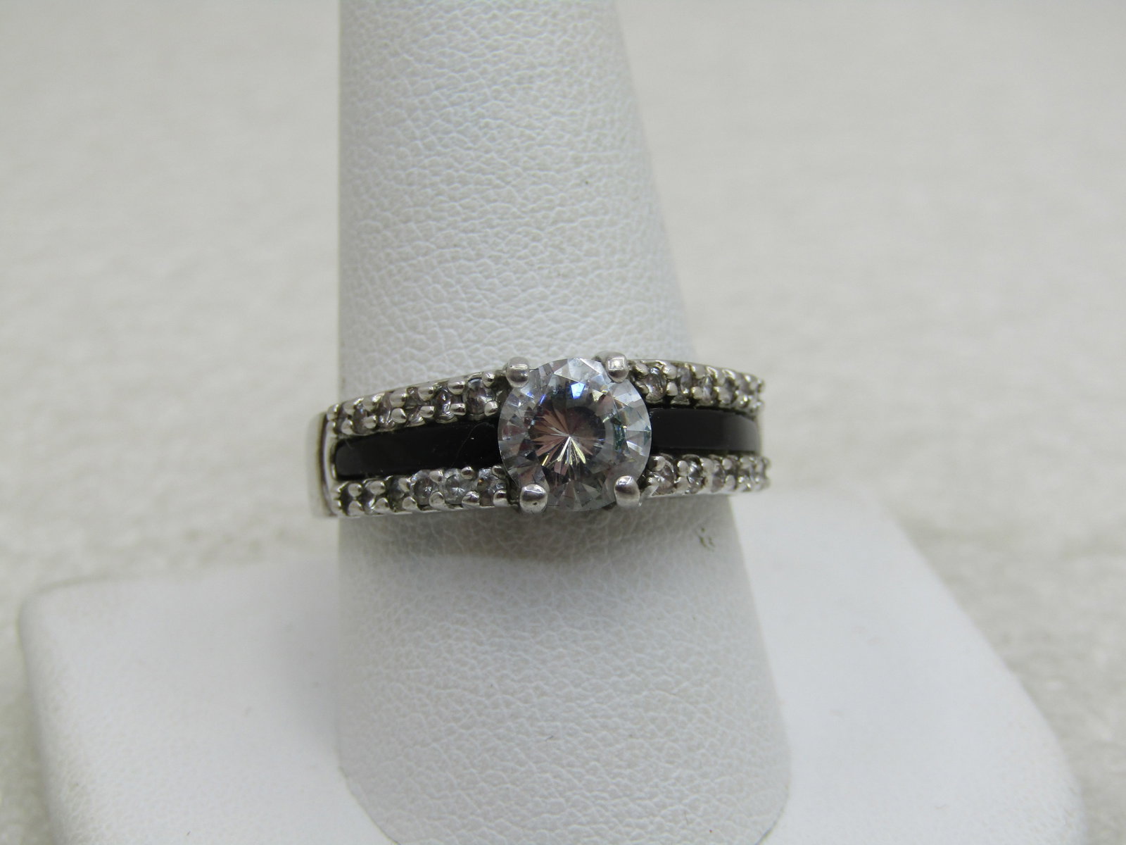 Silver Plated CZ Black & Clear Ring, Sz. 10.5. Tiered, 3 Rows: Title: Silver Plated CZ Black & Clear Ring, Sz. 10.5. Tiered, 3 Rows Description: Silver Plated CZ Black & Clear Ring, Sz. 10.5. Tiered, 3 Rows. Main clear CZ is appx. 6.5mm round cut. The ring is