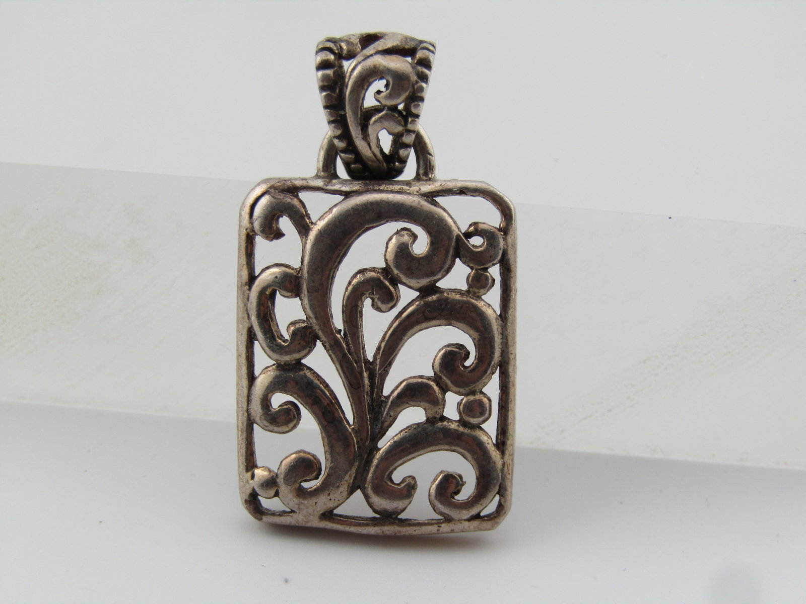 Vintage Sterling Scrolled Pendant, 1980's-1990's: Title: Vintage Sterling Scrolled Pendant, 1980's-1990's Description: Vintage Sterling Scrolled Pendant, 1980's-1990's. T his has an open scrolled rectangular pendant with a scrolled switn bail that ha