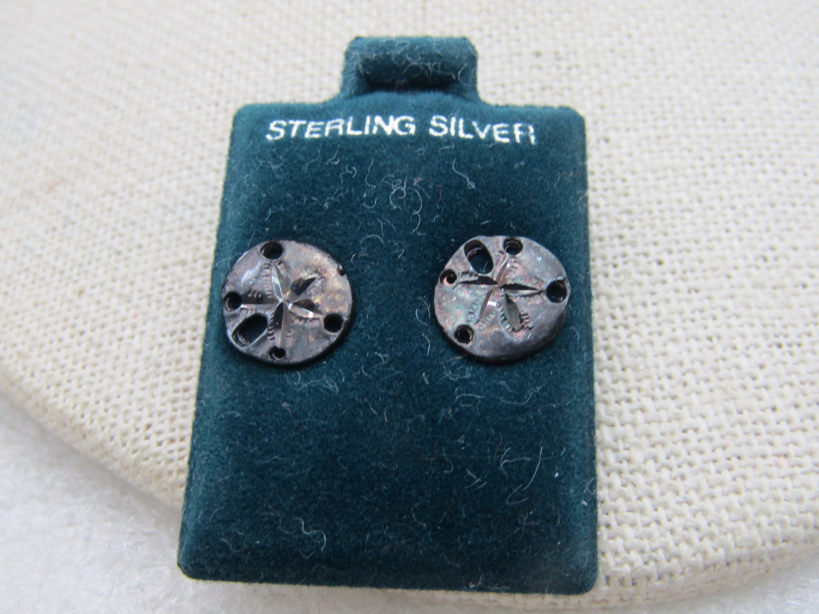Vintage Sterling Silver Sand Dollar Earrings, Pierced, 1/3": Title: Vintage Sterling Silver Sand Dollar Earrings, Pierced, 1/3" Description: Vintage Sterling Silver Sand Dollar Earrings, Pierced, 1/3", 1.2 grams. Vintage new on black velvet card marked sterling