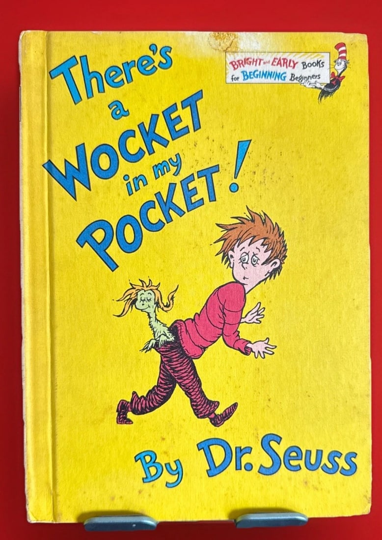 There's a Wocket in My Pocket By Dr. Seuss 1974 Book Club Edition Hardback: There's a Wocket in My Pocket is a vintage 1974 hardback first edition, book club edition written by Dr. Seuss. This illustrated children's book features the author's unique storytelling style and is 