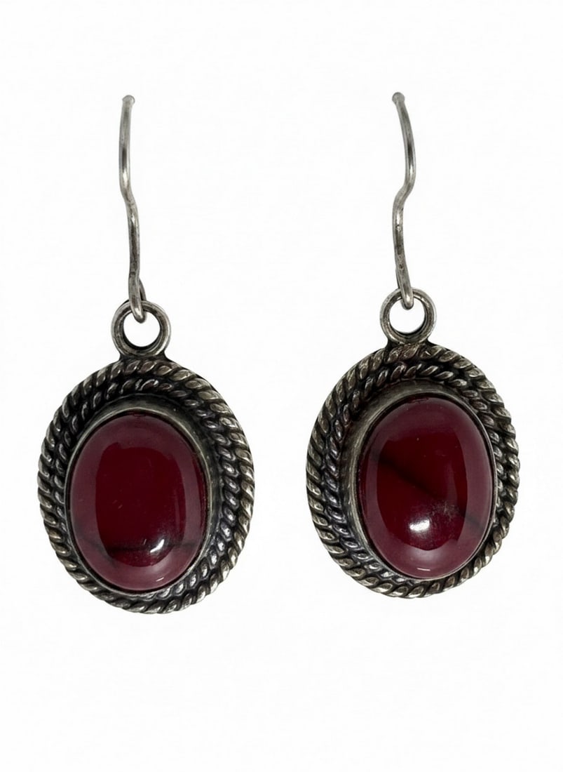 Sterling Silver and Carnelian Stone Drop Earrings, Mexico: A pair of sterling silver drop earrings, each featuring a cabochon cut Carnelian stone set within a twisted rope bezel. The reverse of each earring is stamped "MEXICO". The stones are likely a type