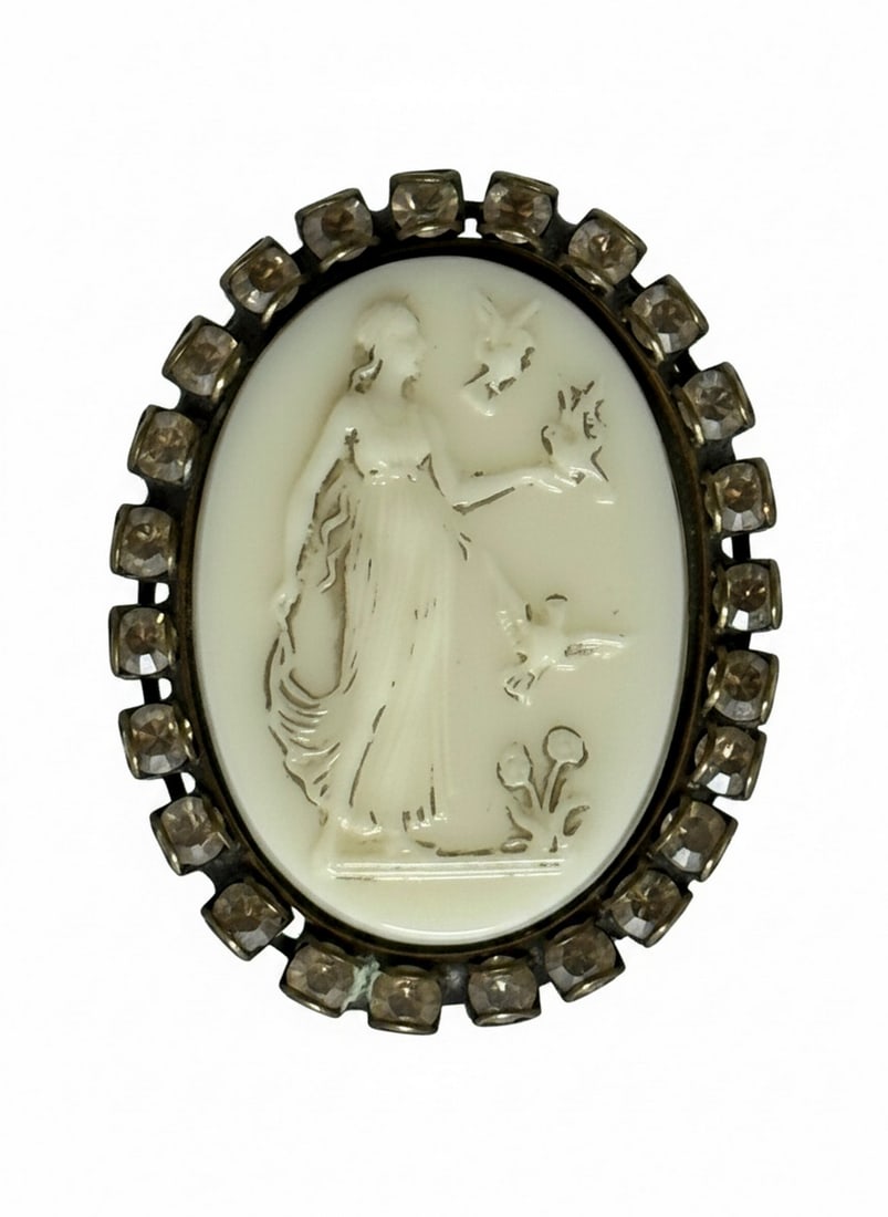 Vintage LIZ PALACIOS S.F. Cameo Ring with Accents: This vintage ring features an oval-shaped cameo depicting a classical female figure holding a balance scale with a dove, surrounded by small botanical elements. The cameo is set in a metal surround