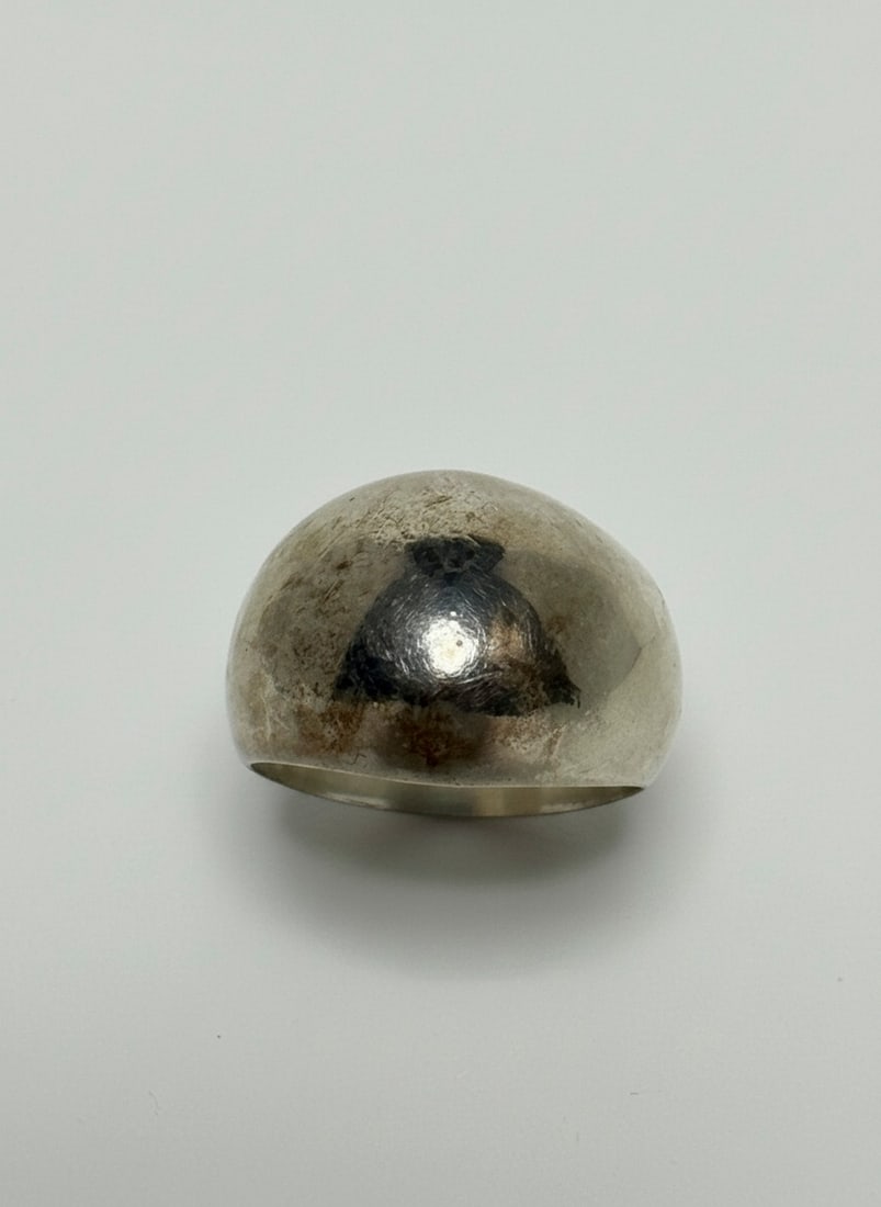Sterling Silver Dome Ring: A contemporary sterling silver dome ring with a sleek, minimalist design. The ring features a highly polished, rounded dome surface and a solid band. Marked "925" for sterling silver. Jewelry Type: