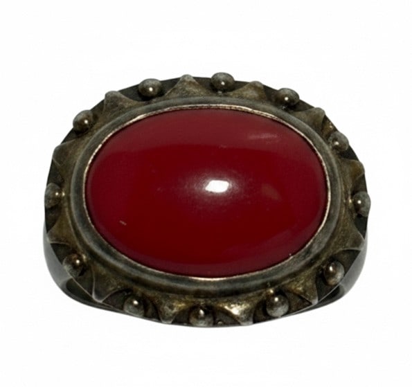 Sterling Silver and Carnelian Coral Cabochon Ring: This ring features a vibrant carnelian coral cabochon set in a sterling silver bezel with bead detailing around the stone. The silver band shows some tarnishing, consistent with age. Jewelry Type: