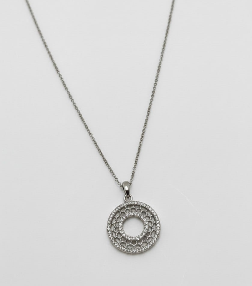 Sterling Silver and Diamond Accent Openwork Circle Pendant Necklace: A contemporary sterling silver necklace featuring an openwork circular pendant adorned with numerous diamond accents, creating a glittering design. The pendant hangs from a delicate silver chain with