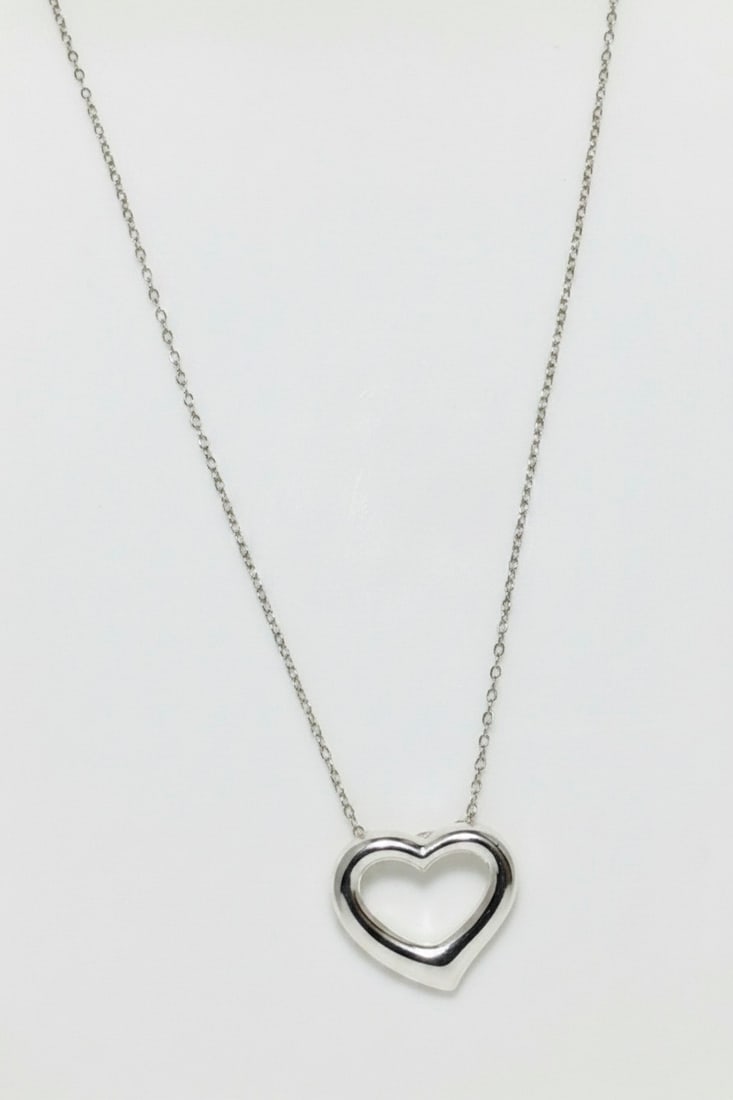 Sterling Silver Open Heart Pendant Necklace: A delicate sterling silver open heart pendant necklace with a fine chain. The popular open heart design is a classic symbol of love and affection, making this a versatile piece suitable for everyday w