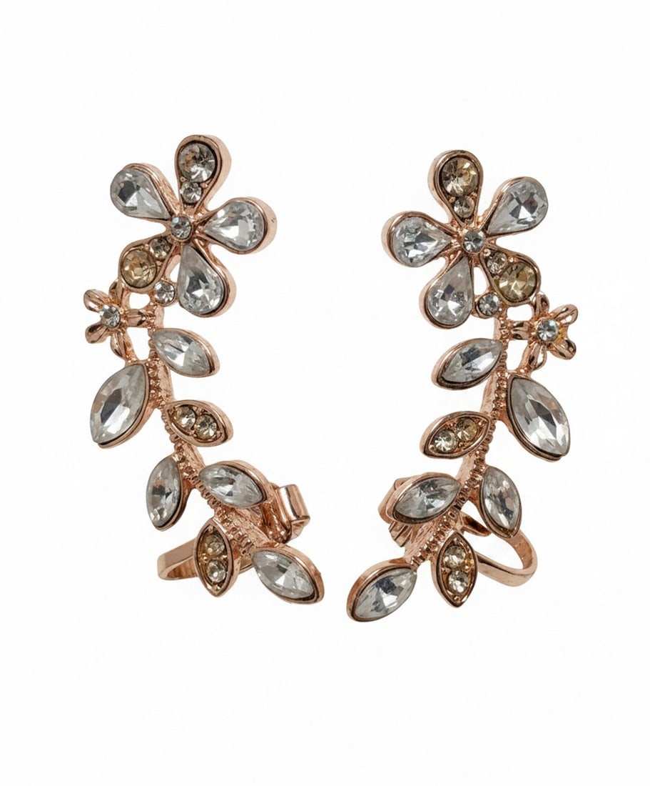 Pair of Rose Gold-Tone and Clear Stone Climber Earrings: A pair of contemporary rose gold-tone climber earrings, each featuring a botanical design with multiple clear faceted stones in various shapes and sizes. The earrings are designed to "climb" up the