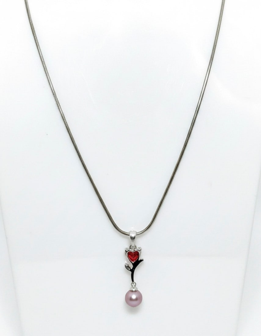 Sterling Silver Heart and Pearl Pendant Necklace: A sterling silver necklace featuring a pendant with a heart-shaped red stone (possibly garnet or cubic zirconia) set above a freshwater pearl. The pendant also incorporates a small silver leaf accent