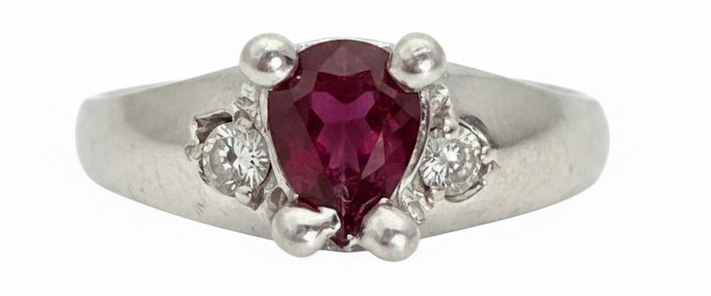 Sebastian Sterling Silver Pear-Cut Ruby and Diamond Accent Ring: Fashioned in sterling silver, this ring features a prominent pear-cut ruby as its center stone. The ruby is flanked by two small diamond accents, set in a classic design. The silver band is marked