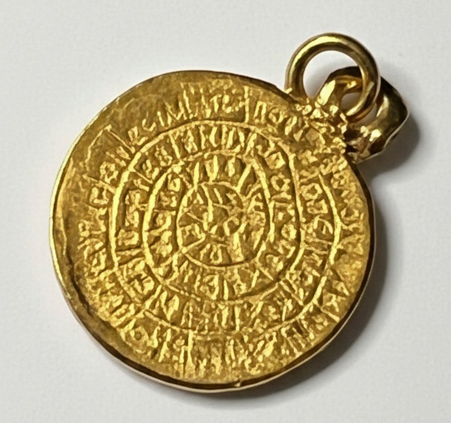 Phaistos Disc Inspired Gold-Plated Sterling Silver Pendant: This vintage gold-plates sterling silver pendant features a design inspired by the ancient Phaistos Disc, an archaeological enigma from Minoan Crete. The disc-shaped pendant has a spiraling pattern of