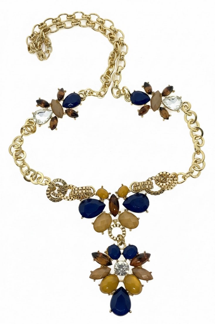 Contemporary Gold-Tone and Multi-Stone Fashion Necklace: This contemporary fashion necklace features a substantial gold-tone chain adorned with clusters of faceted glass stones in shades of navy blue, amber, brown, and clear. The stations are arranged