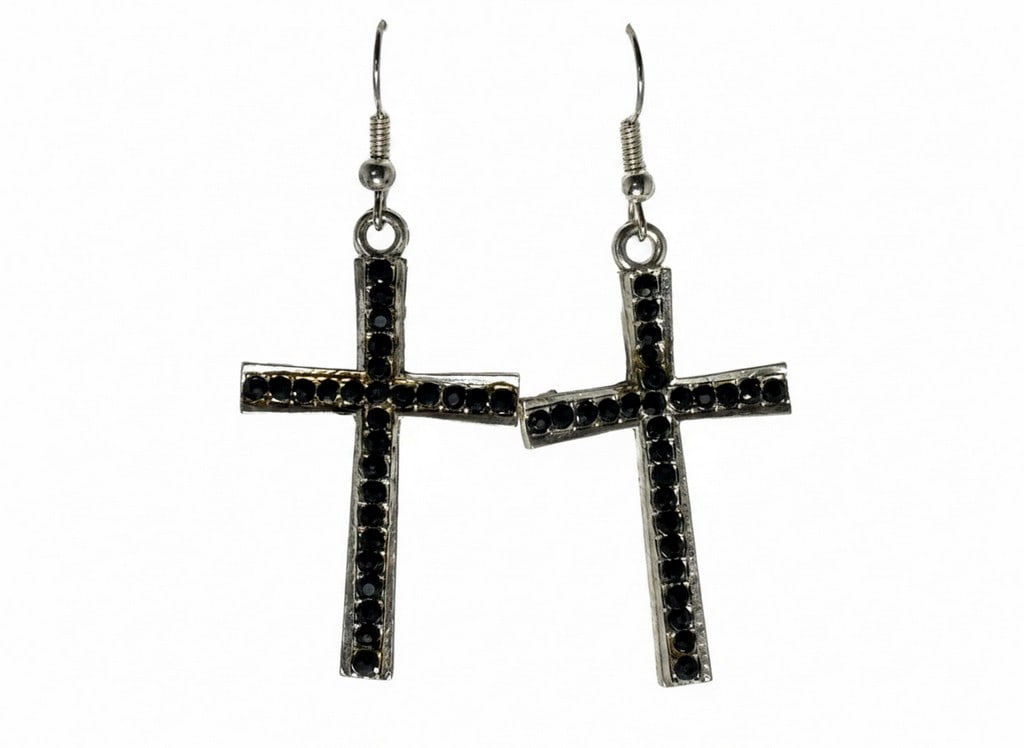Pastel Collection Silver-Tone and Black Rhinestone Cross Dangle Earrings: A pair of fashion dangle earrings from the Pastel Collection, featuring silver-tone metal crosses adorned with numerous small black rhinestones. The earrings have a textured, slightly antiqued