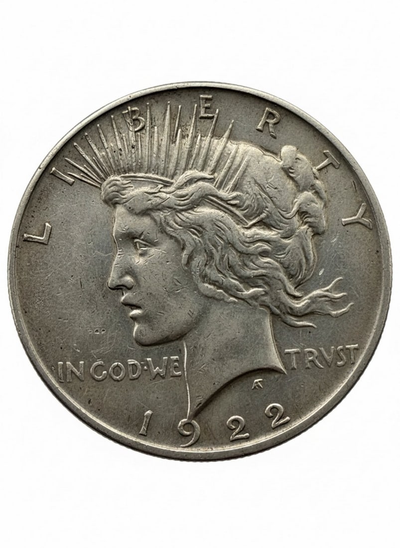 1922 United States Peace Silver Dollar: A 1922 United States Peace Silver Dollar. The obverse features a left-facing profile of Lady Liberty with a radiate crown, inscribed "LIBERTY" and "IN GOD WE TRVST" and the year "1922". The reverse