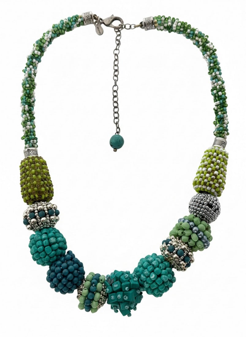 Artisan Seed Bead and Ball Bead Necklace: This vibrant necklace features a variety of seed beads and larger ball beads in shades of green, teal, and blue, with silver-toned accents. The necklace has an adjustable chain closure, ending with a
