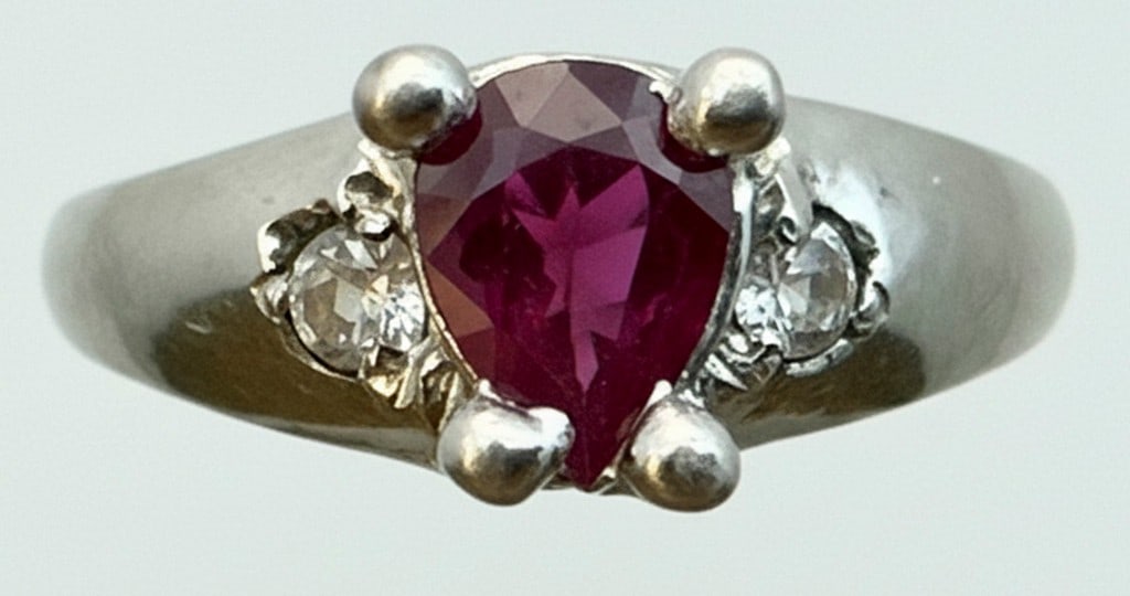 10K Gold Marquise Garnet & Diamond Accent Ring: This elegant ring features a marquise-cut garnet as the focal point, flanked by diamond accents set in a bypass-style 10K yellow and white gold band. The garnet exhibits a deep red hue and is