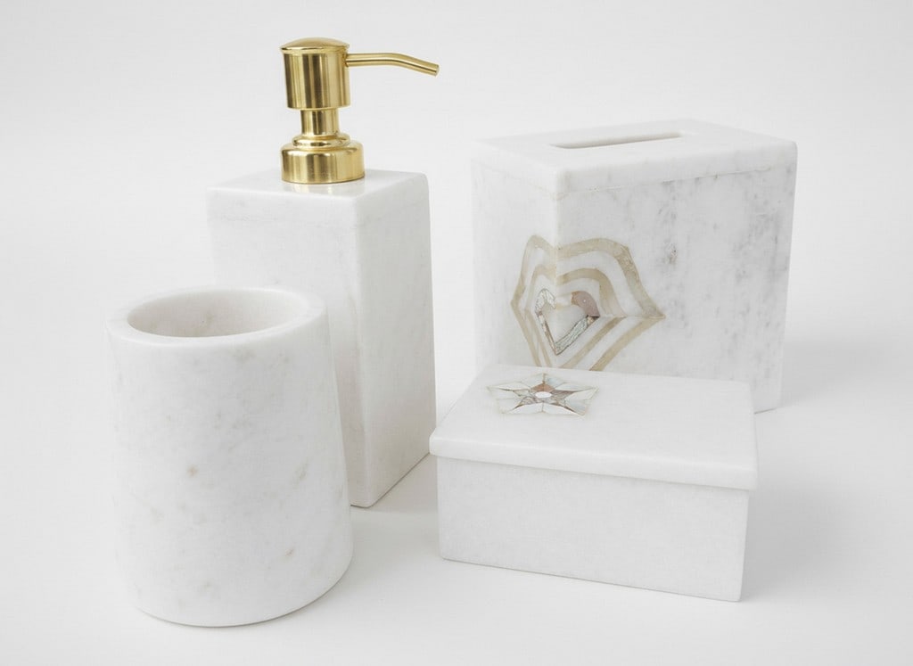 Five-Piece White Marble Bathroom Vanity Set with Mother-of-Pearl Inlay.: A five-piece white marble bathroom vanity set featuring polished surfaces and ornate mother-of-pearl inlay designs. The set includes a soap pump dispenser with a brass-toned pump, a tissue box cover w