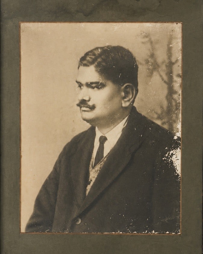 Large Portrait of an Indian Gentleman India, Early 20th Century Silver gelatin photograph, Original: A dignified early 20th-century portrait photograph depicting an Parsi - Indian gentleman seated in formal pose, dressed in a traditional cap and tailored jacket. Executed in the restrained studio