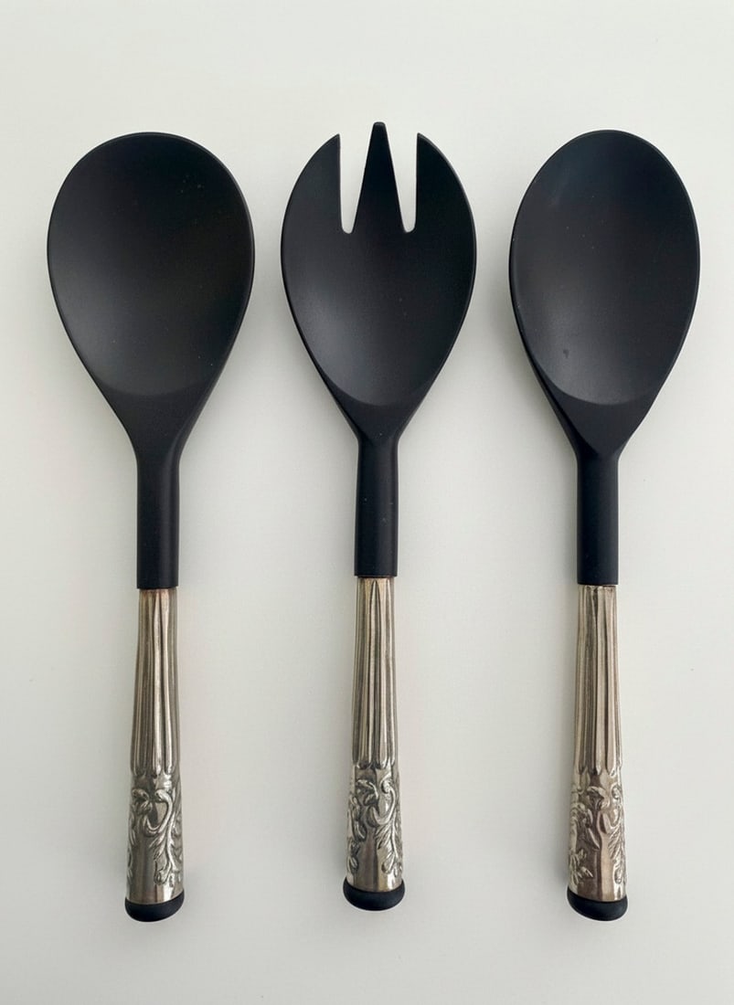 Set of Three Good Earth Salad Servers with Ornate Silver-Plated Handles: An elegant three-piece salad serving set by Good Earth, featuring sculptural ebonized wood serving utensils accented with silver-plated handles finely cast with scrolling foliate decoration. The