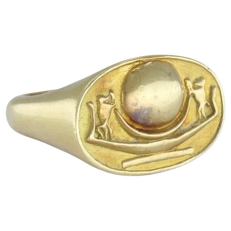 Vintage 1978 Egyptian Revival 18k Gold Signet Ring: 18k yellow gold figural signet ring, dated 1978, designed with a broad oval face and a raised central motif. The face features two monkey figures flanking a rounded central form, giving the ring an an