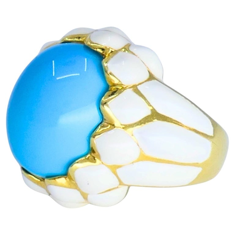 David Webb Ring 18k Gold White Enamel Turquoise Cocktail Ring: A vintage David Webb ring, made of 18k gold and white enamel, featuring a substantial oval cabochon turquoise. The vivid blue gemstone is framed by a textured pattern of glossy white enamel, creating