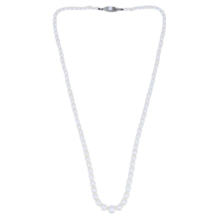 Vintage Mikimoto Akoya Pearl Graduated Necklace with Silver Clasp: Mikimoto cultured Akoya pearl necklace, designed as a single strand of white pearls finished with a sterling silver clasp. The clasp features the Mikimoto â€œMâ€ insid