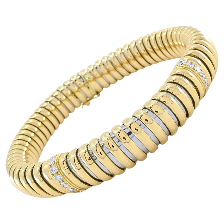 Vintage Cartier 18k Gold & Stainless Steel Tubogas Diamond Bracelet: A vintage Cartier bracelet in the classic tubogas style, crafted from 18k yellow gold and stainless steel. Tubogas is a flexible coil construction known for its smooth, continuous form and