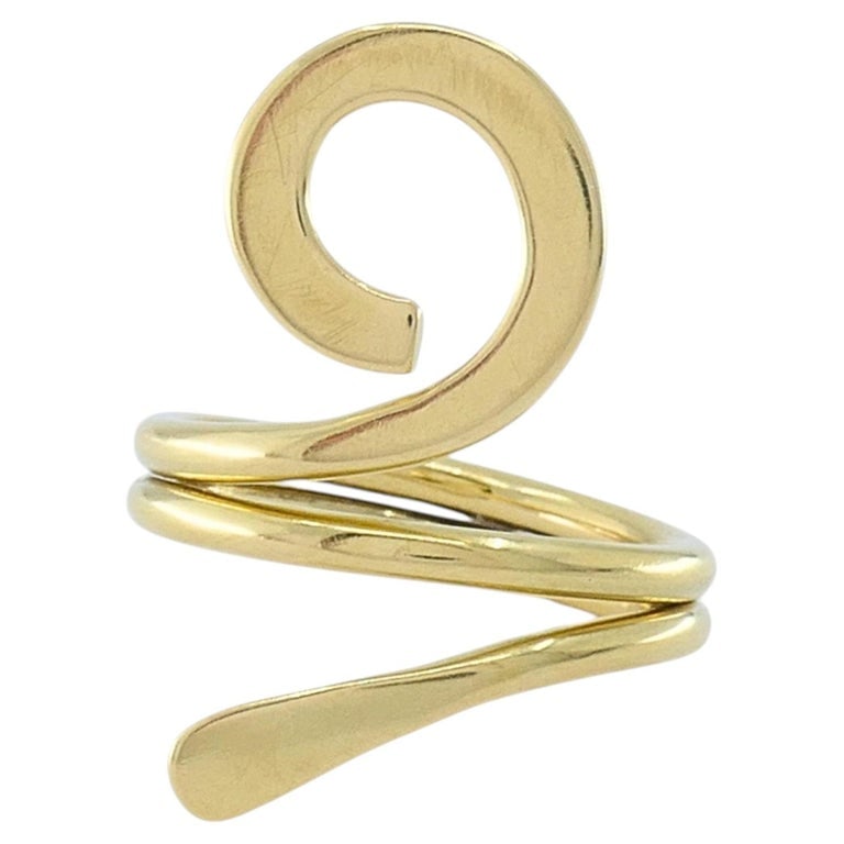 Cartier Dinh Van 18k Yellow Gold Vintage Ankh Ring: Cartier Dinh Van Ankh ring crafted in 18k yellow gold, designed with a sculptural spiral that wraps around the finger. The form suggests an abstract ankh, and the polished surface reflects light clean