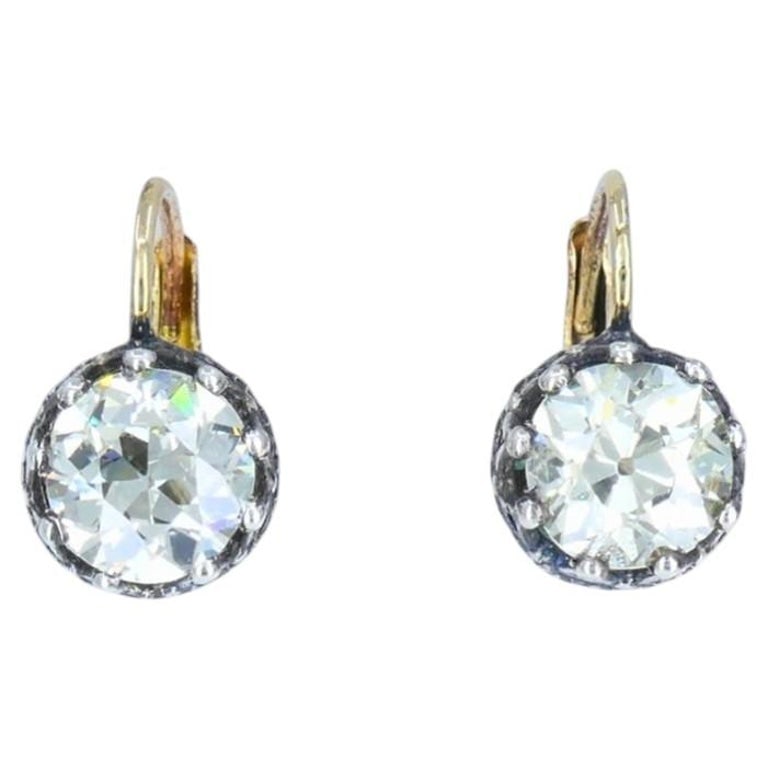 Victorian Diamond Drop Earrings 14k Gold Silver Old European Cut, Antique: A pair of Victorian diamond earrings made of 14k yellow gold and silver settings. The earrings feature two Old European cut diamonds weighing approximately 1.64-carat and 1.68-carat. Their hand-cut fa