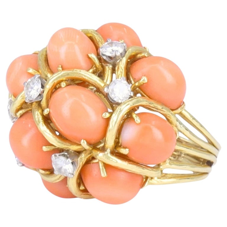 David Webb 18k Gold Coral Diamond Cocktail Dome Ring: David Webb 18k yellow gold coral and diamond cocktail ring, circa 1960s to 1970s, designed with a dimensional cluster of oval coral cabochons accented by diamonds set in white gold. The ring features