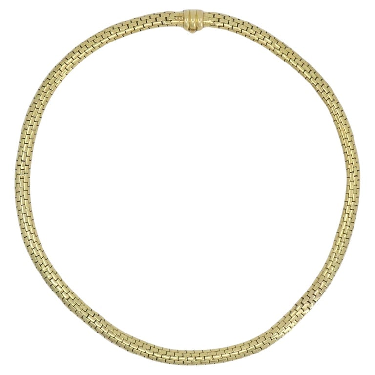 Cartier Paris 18k Gold Flexible Link Collar Necklace Mid-Century: Cartier Paris 18k gold flexible collar necklace, circa 1950s to 1960s, designed with an articulated brick link construction that creates a smooth curved profile around the neckline. The necklace is