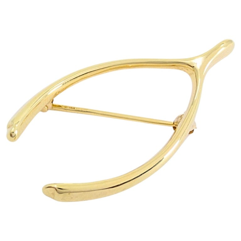 Tiffany & Co. 14k Yellow Gold Wishbone Brooch Pin: Designer: Tiffany & Co. Materials: 14K Yellow Gold Weight: 4.2 Grams Measurement: 3/4" x 1 1/2" Hallmarks: 14K, Tiffany A vintage Tiffany & Co. wishbone brooch made in 14k yellow gold. The