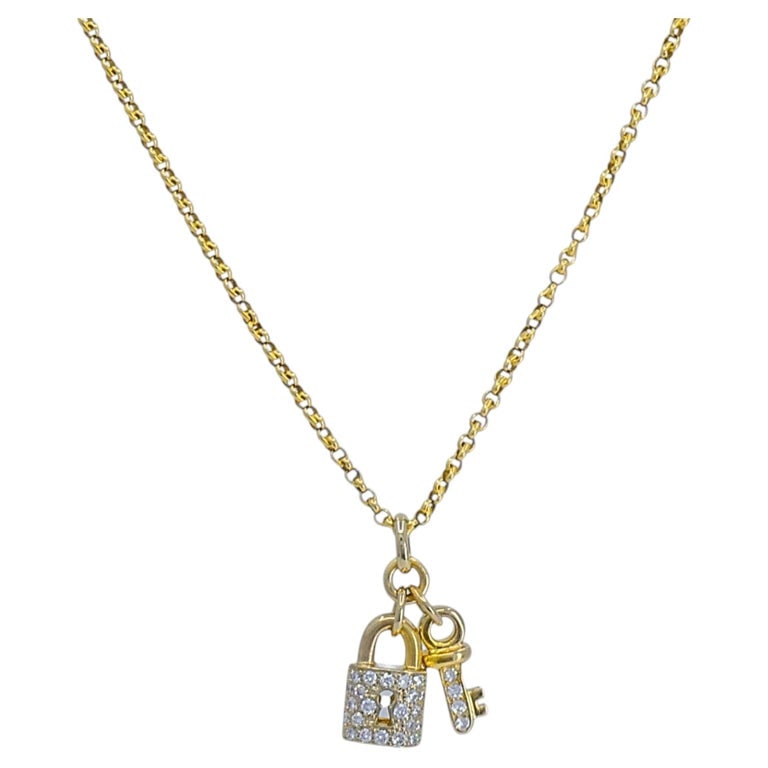 14k Gold Diamond Lock & Key Pendant Necklace: This 14k gold necklace with a diamond-set lock and key pendant. The lock features a pave diamond face with a keyhole cutout, while the matching key is set with diamonds down the shaft. Both charms han