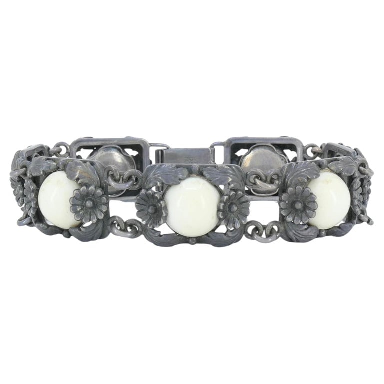 Vintage N.E. From Denmark Sterling Silver Bone Cabochon Bracelet: Vintage N.E. From sterling silver and bone bracelet, circa 1940s to 1950s, crafted in Denmark. The bracelet is composed of rectangular openwork links with raised floral and foliate detailing, each