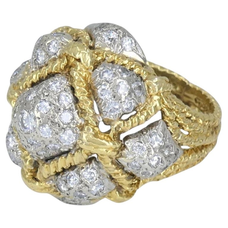 Vintage 18k Yellow Gold and 14k White Gold Diamond Dome Cocktail Ring: Vintage two tone diamond dome cocktail ring, circa 1970s, crafted in 18k yellow gold with 14k white gold diamond set accents. The ring features a bold domed bombe form with a dimensional cluster top