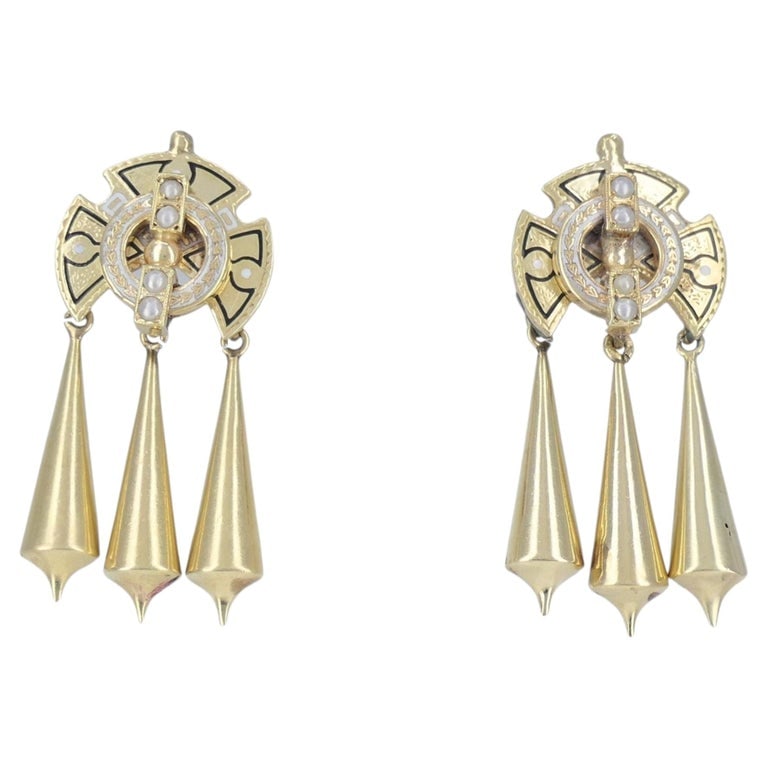 Victorian 14k Gold Enamel Seed Pearl Mechanical Drop Earrings: These Victorian 14k gold enamel and seed pearl drop earrings date to the late 19th century and feature an Etruscan Revival design with articulated movement. Each earring is composed of a shield