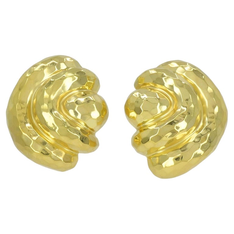 Vintage Henry Dunay 18k Gold Hammered Shell Motif Clip Earrings: These vintage Henry Dunay earrings are crafted in 18k yellow gold and feature a sculptural shell motif with a rounded folded fan form. The design is built with layered, curved ridges that create