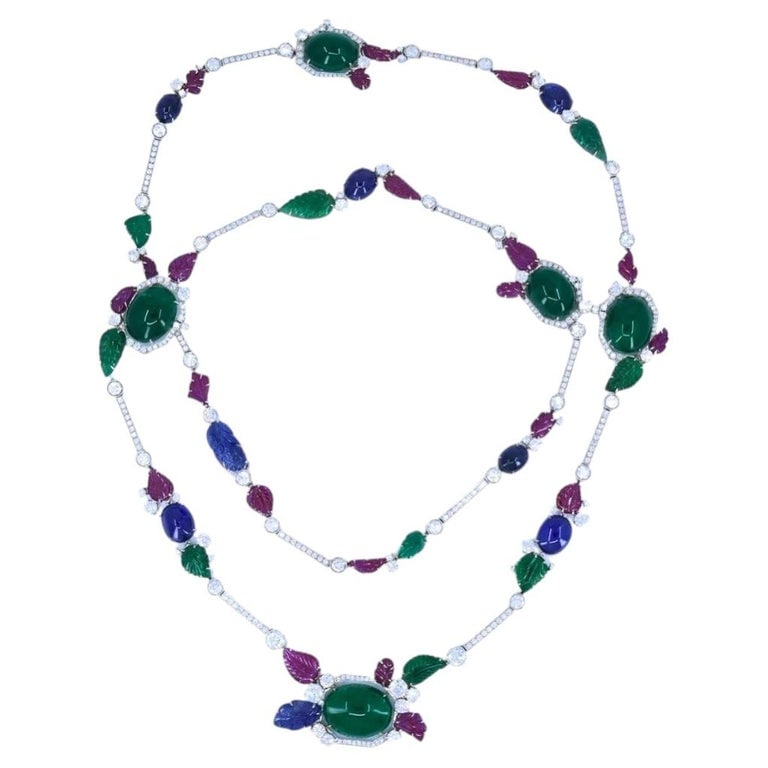 Sabbadini Tutti-Frutti Necklace 18k White Gold Carved Gemstones: A Sabbadini tutti-frutti design necklace, crafted in 18k white gold, featuring gemstones. The design features an intricate arrangement of carved ruby, emerald, and sapphire, with round brilliant cut