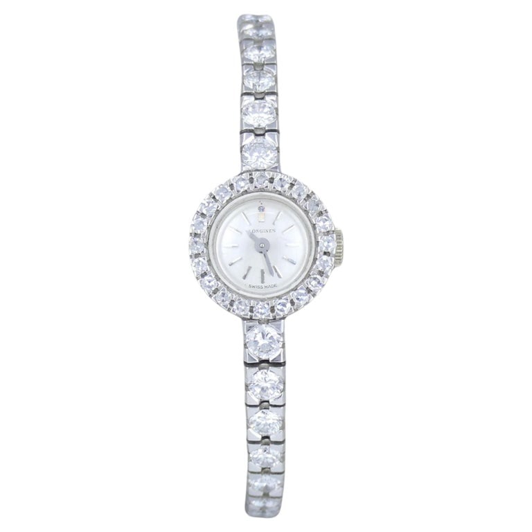 Vintage Longines Swiss 18k White Gold Diamond Lady's Wrist Watch: Longines 18k white gold diamond cocktail watch featuring a circular case framed by a full halo of round diamonds, with additional graduated diamonds extending along the lugs into a flexible bracelet