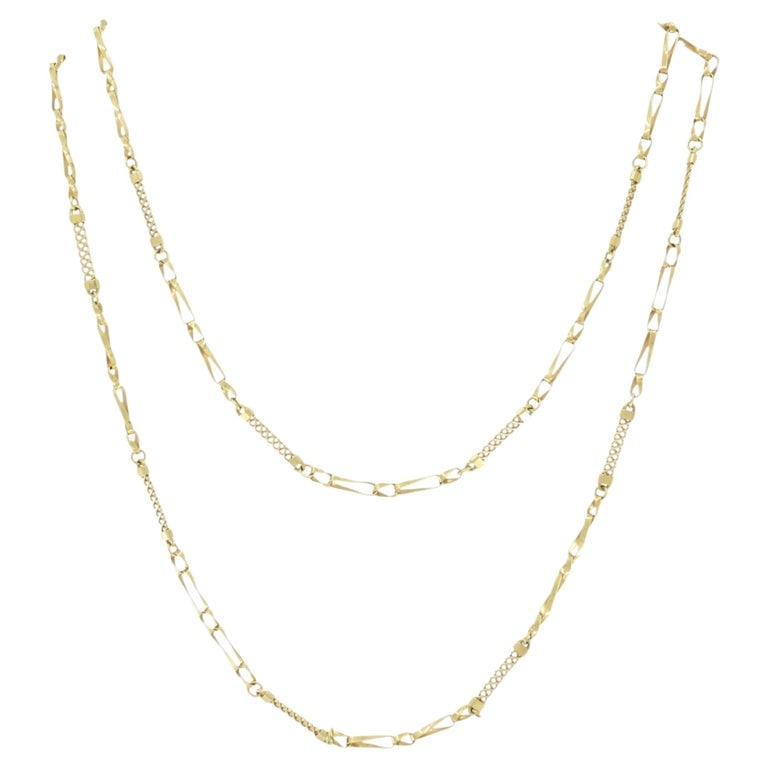 Vintage 18k Yellow Gold Chain Necklace 36â€ Long: A vintage 18k yellow gold chain necklace that stands out with its whimsical pattern. Crafted in solid 18k gold. The design features alternating elongated and textured links, creating a long link chain