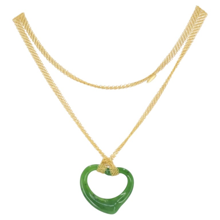 Elsa Peretti for Tiffany & Co. 18k Gold Jade Open Heart Mesh Necklace: A vintage Elsa Peretti for Tiffany & Co. 18k gold and jade Open Heart mesh necklace. The piece features a refined combination of fluid form and distinctive textures. The design includes a gold