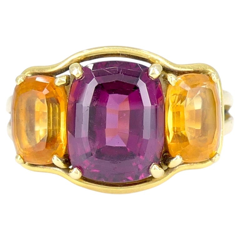 Verdura 18k Gold Rubellite and Madeira Citrine Three Stone Ring: This Verdura three stone ring is crafted in 18k yellow gold and set with a central rubellite, flanked by two Madeira citrine gemstones. The composition reflects Verduraâ€™s enduring