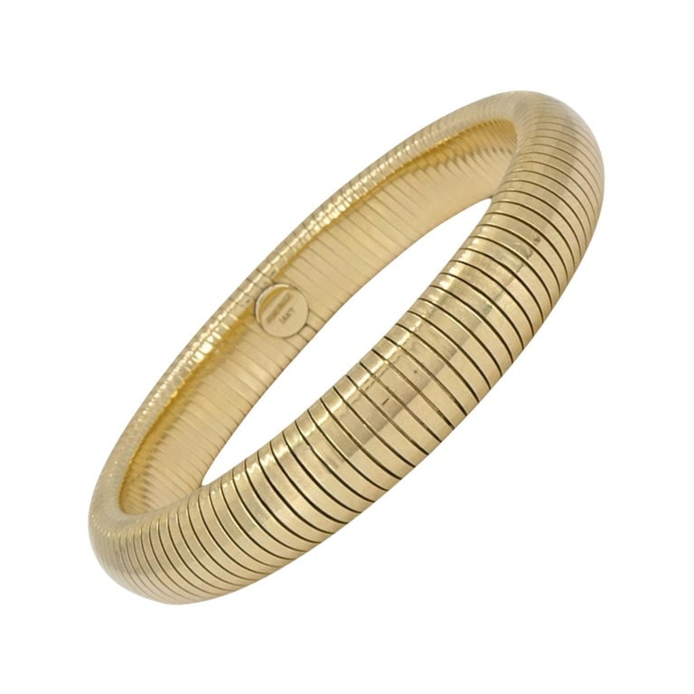 Forstner 14k Gold Bracelet Tubogas Style: This 14k gold Tubogas bracelet by Forstner features the iconic flexible coil construction that defines the classic Tubogas style. The bracelet is formed from tightly wrapped gold bands, creating a