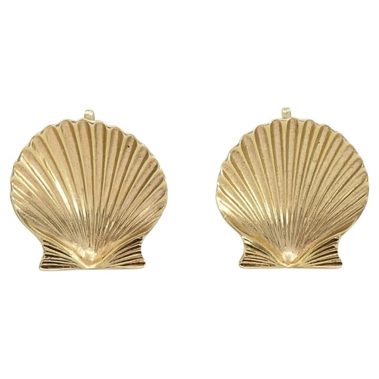 Cartier 14k Gold Shell Vintage Clip-On Earrings: DESIGNER: Cartier CIRCA: 1960s MATERIALS: 14k Gold WEIGHT: 9.1 Grams MEASUREMENTS: 13/16" x 13/16" HALLMARKS: Cartier, 14K & serial number ITEM DETAILS: A pair of vintage Cartier earrings in 14k